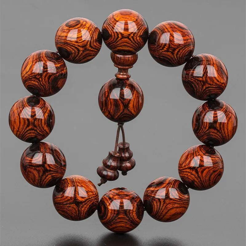 Hainan Sea-Yellowwood Bracelet — Ghost-Eye Grain Carving